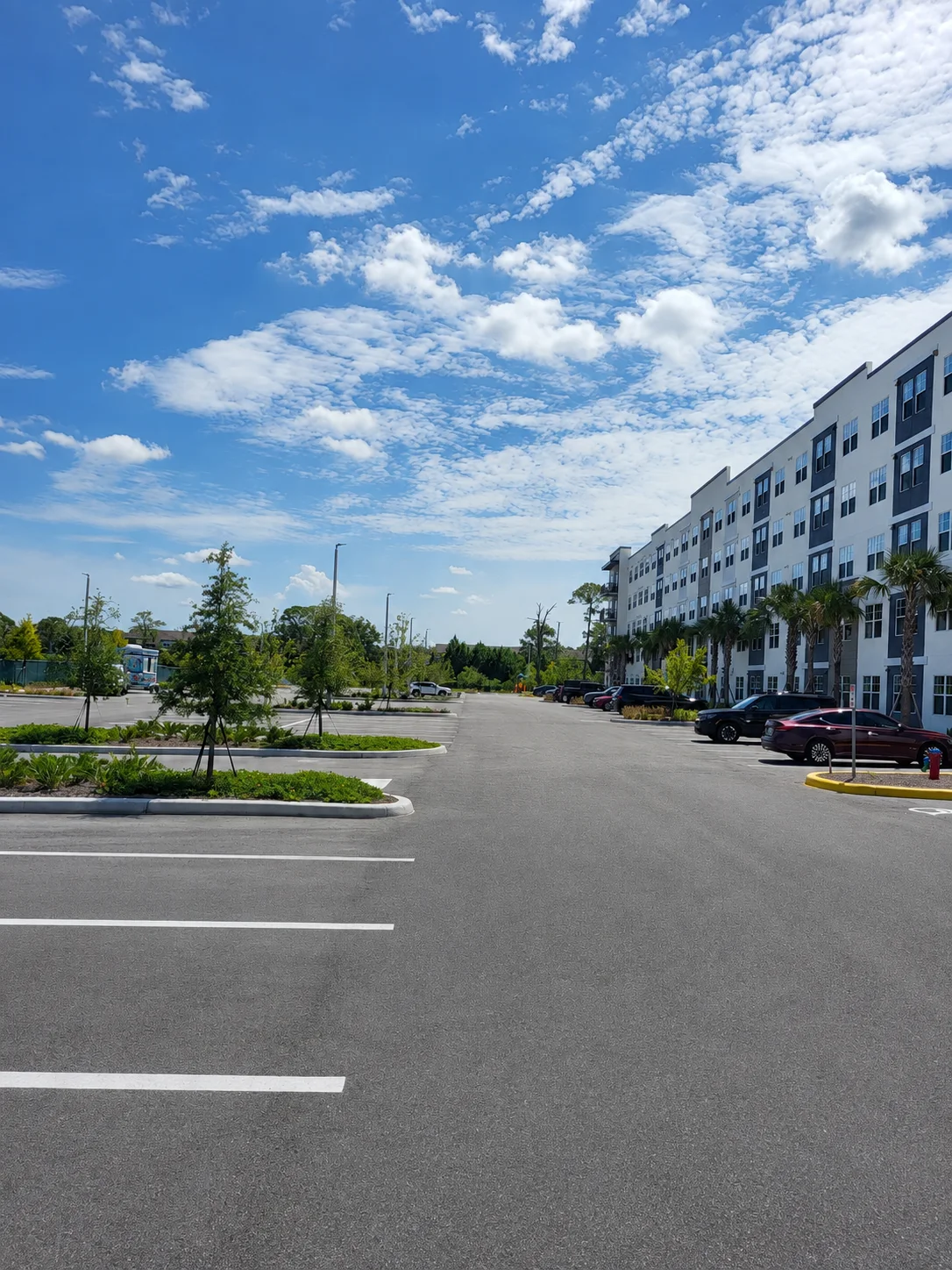Millenia Park Apartments parking area with planted islands and building frontage